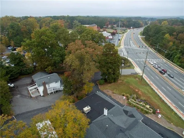 an aerial view of a house with a yard