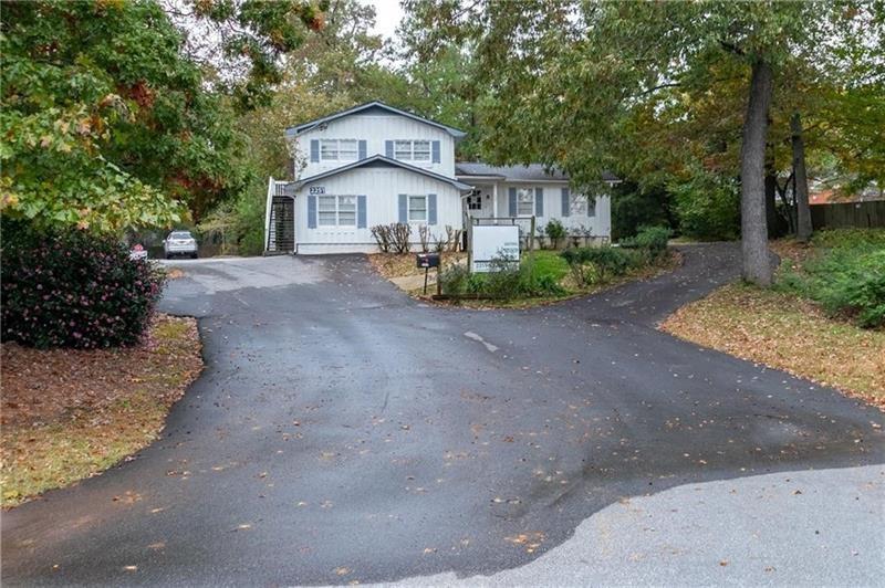 2251 Roswell Road Northeast Marietta, GA 30062 - Photo 8 of 12 a view of a house with a yard and large trees