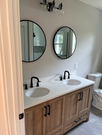 19 Indian Road, Unit B Groton, MA 01450 - Photo 19 of 27 a bathroom with 2 sink and a mirror