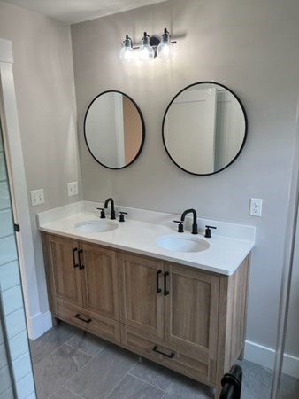 19 Indian Road, Unit B Groton, MA 01450 - Photo 22 of 27 a bathroom with a double vanity sink and a mirror