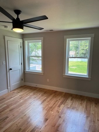 19 Indian Road, Unit B Groton, MA 01450 - Photo 27 of 27 a view of an empty room with wooden floor and a window