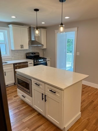 19 Indian Road, Unit B Groton, MA 01450 - Photo 4 of 27 a kitchen with a stove window and cabinets