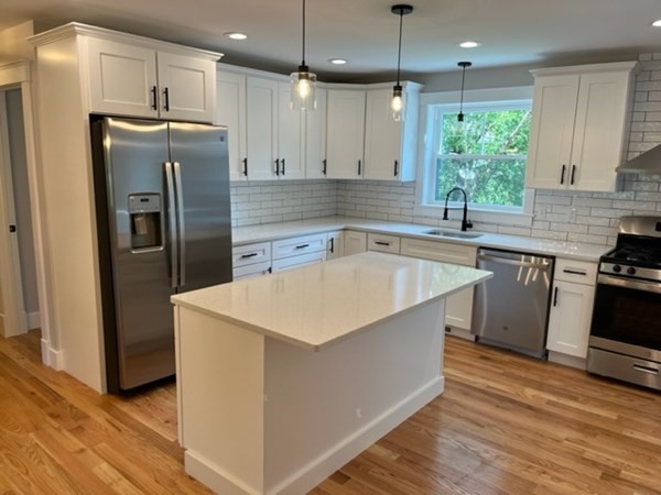 19 Indian Road, Unit B Groton, MA 01450 - Photo 5 of 27 a kitchen with stainless steel appliances granite countertop a sink stove and refrigerator