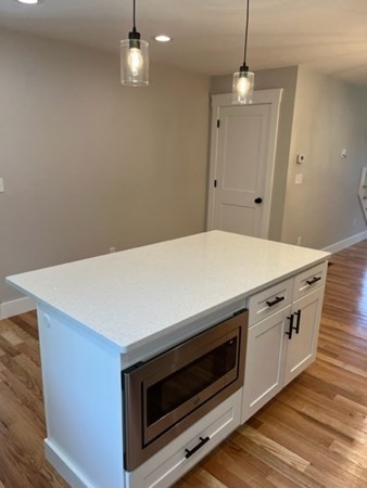 19 Indian Road, Unit B Groton, MA 01450 - Photo 7 of 27 a stove top oven sitting inside of a kitchen