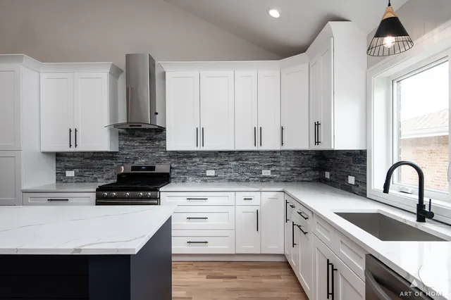 a kitchen with granite countertop a sink a stove and cabinets