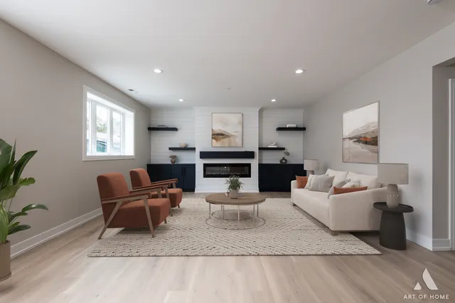 a living room with fireplace furniture and a wooden floor