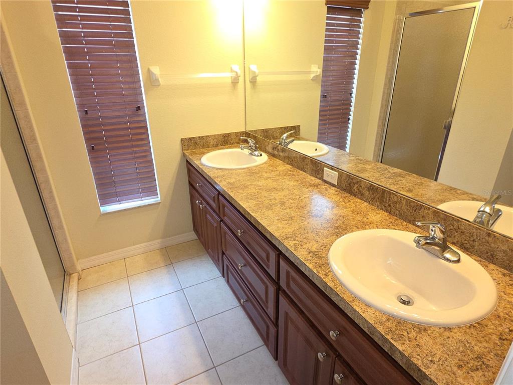 4284 High Ridge Avenue Spring Hill, FL 34609 - Photo 10 of 40 a bathroom with a granite countertop sink and a mirror