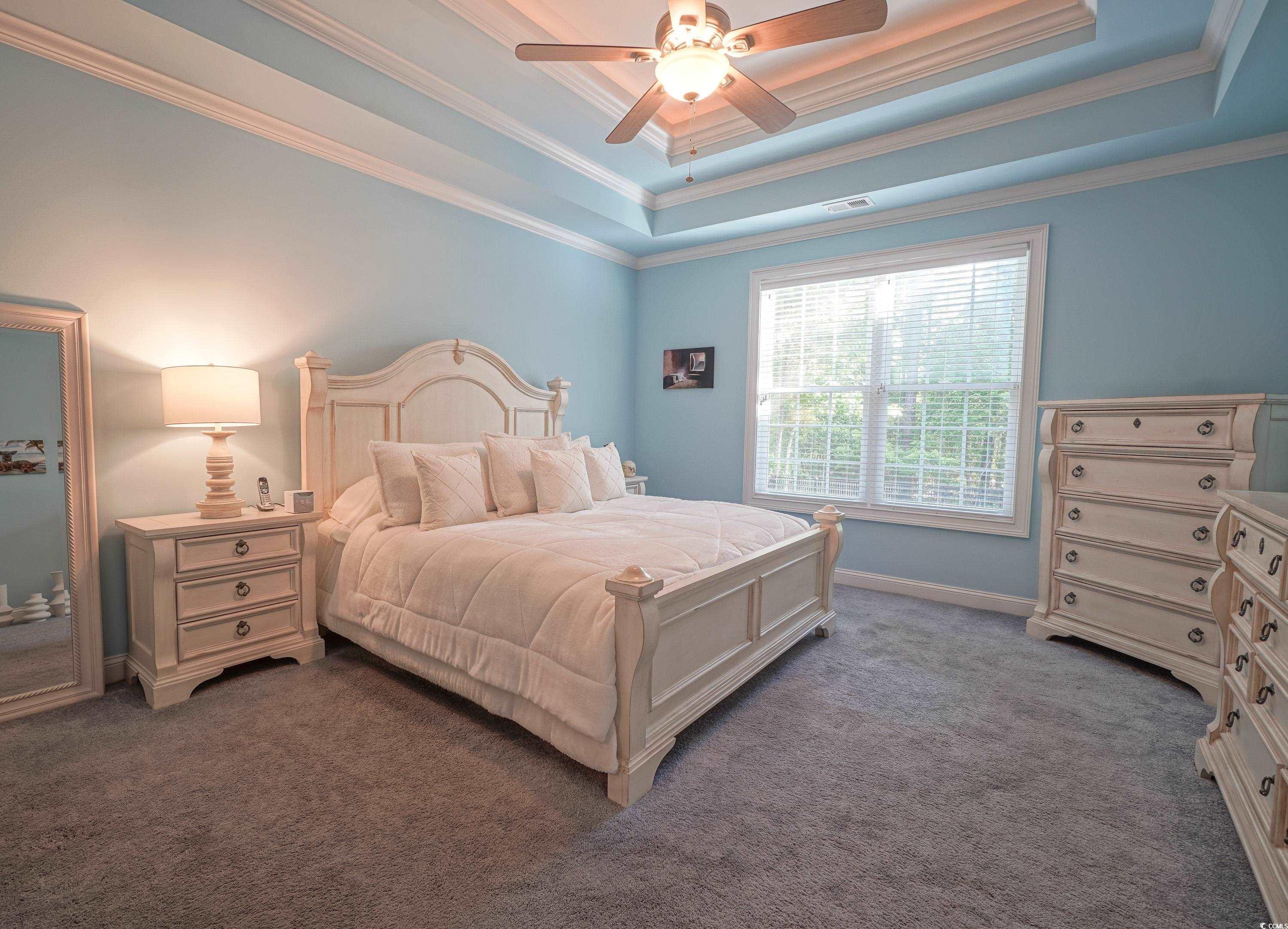 625 Whispering Pines Court Murrells Inlet, SC 29576 - Photo 13 of 36 Bedroom featuring carpet floors, a ceiling fan, crown molding, and a raised ceiling