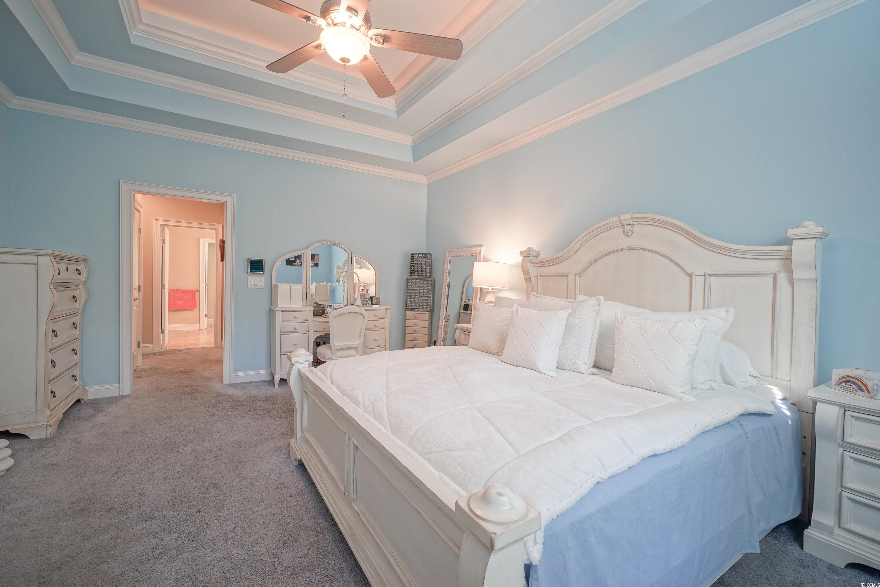 625 Whispering Pines Court Murrells Inlet, SC 29576 - Photo 14 of 36 Bedroom featuring a ceiling fan, a raised ceiling, baseboards, ornamental molding, and carpet