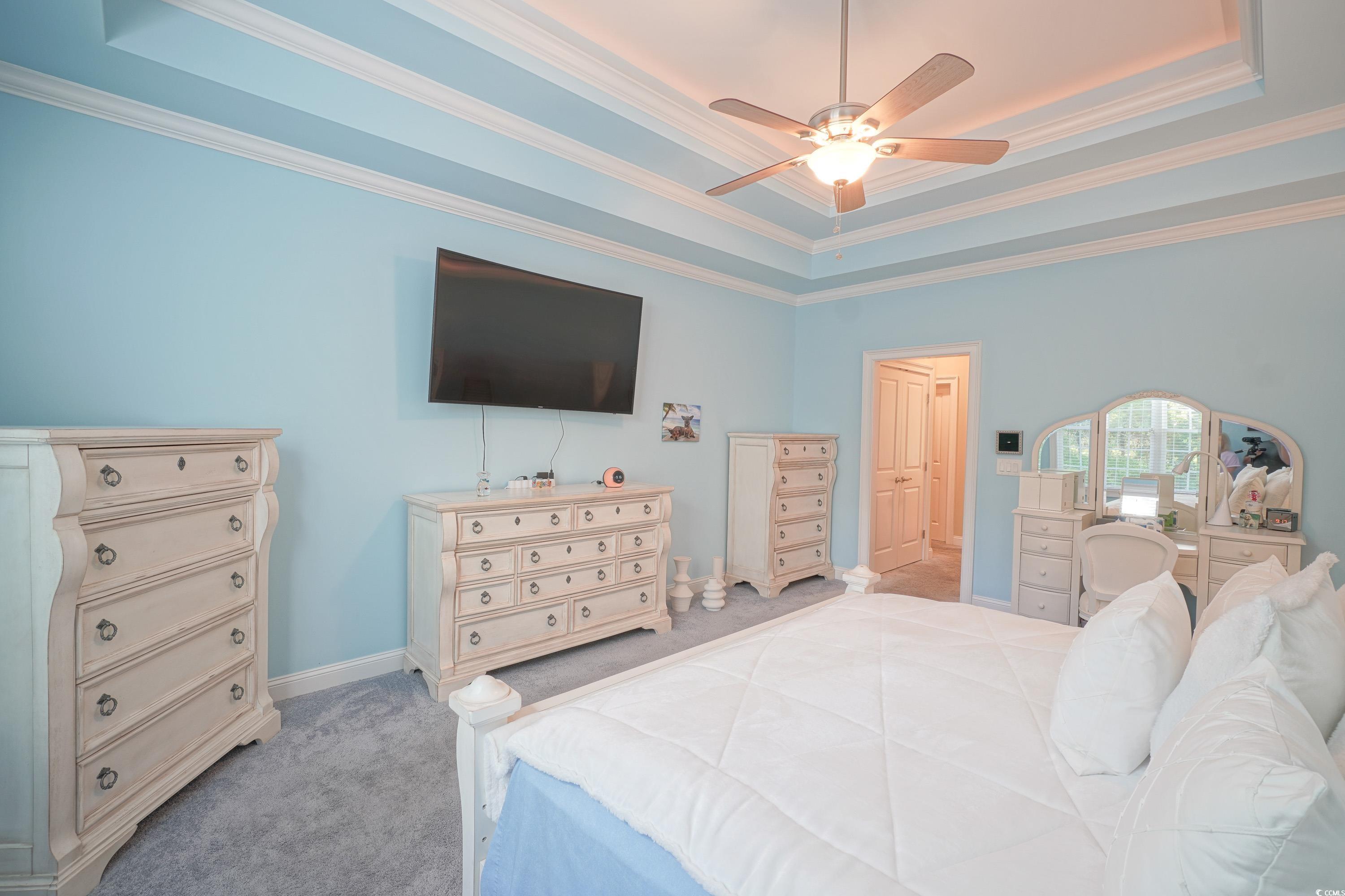 625 Whispering Pines Court Murrells Inlet, SC 29576 - Photo 15 of 36 Bedroom featuring ornamental molding, light carpet, and a tray ceiling