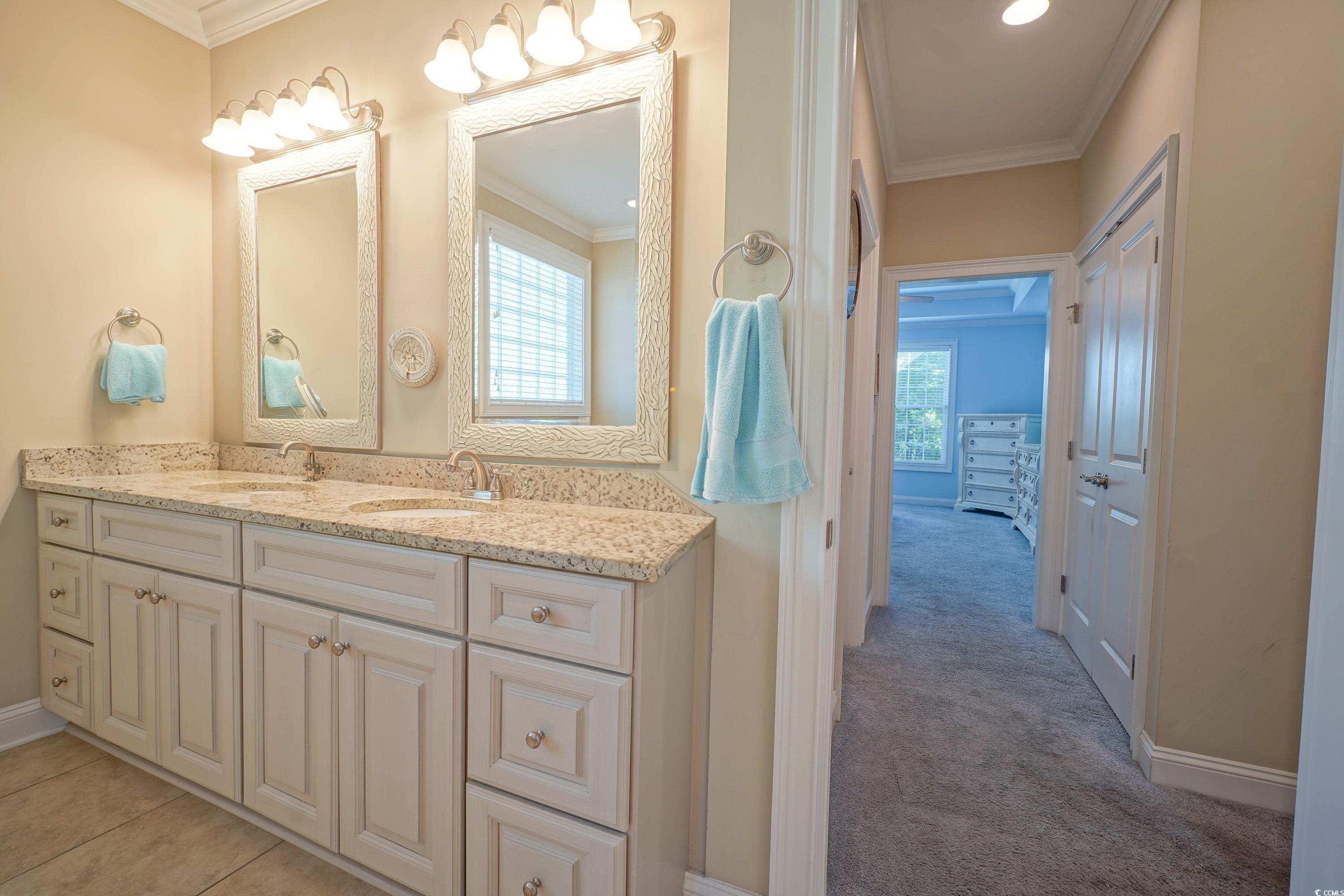 625 Whispering Pines Court Murrells Inlet, SC 29576 - Photo 16 of 36 Full bath featuring double vanity, baseboards, ornamental molding, and a sink