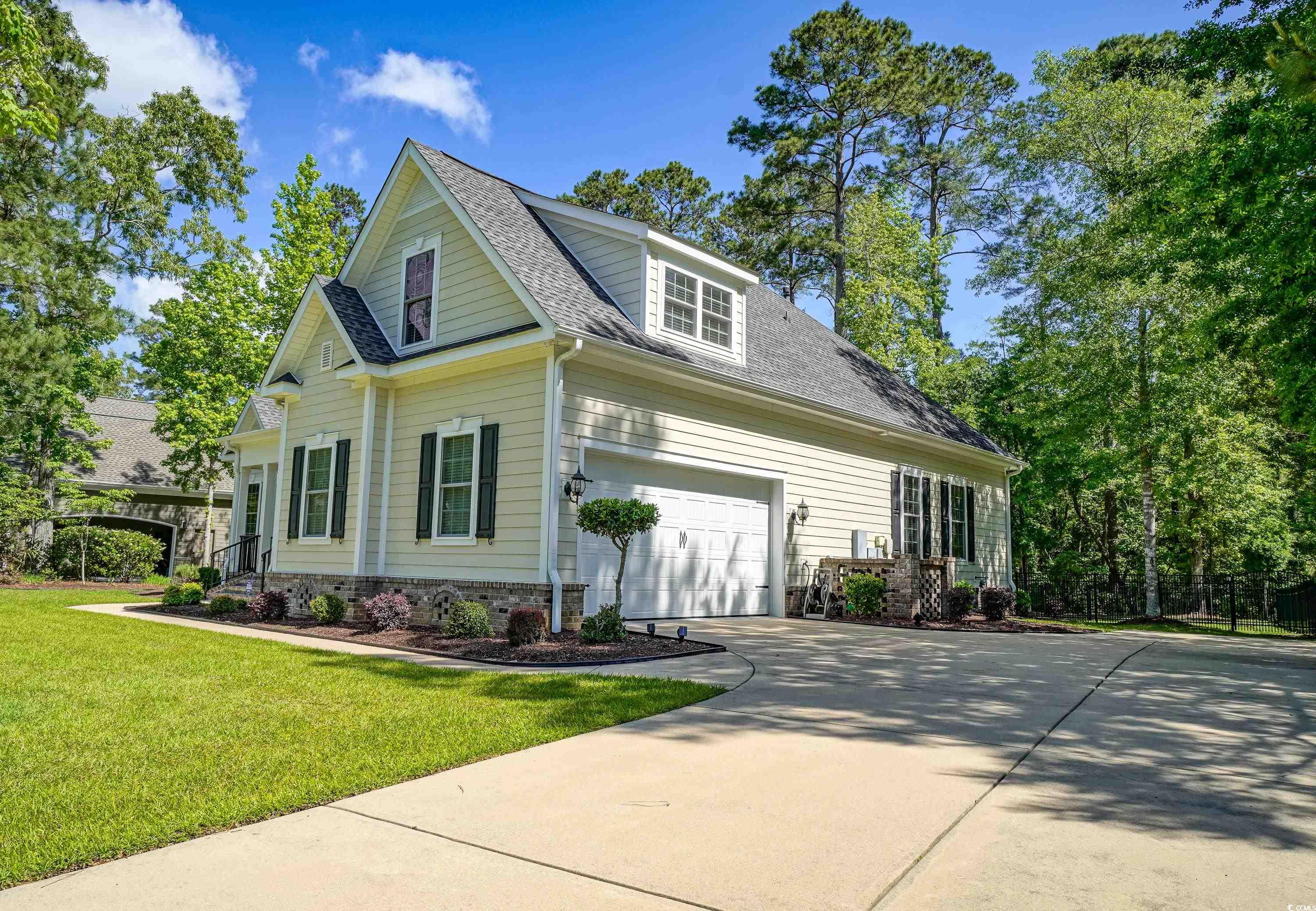 625 Whispering Pines Court Murrells Inlet, SC 29576 - Photo 2 of 36 View of front of property with a shingled roof, a front lawn, brick siding, a garage, and driveway