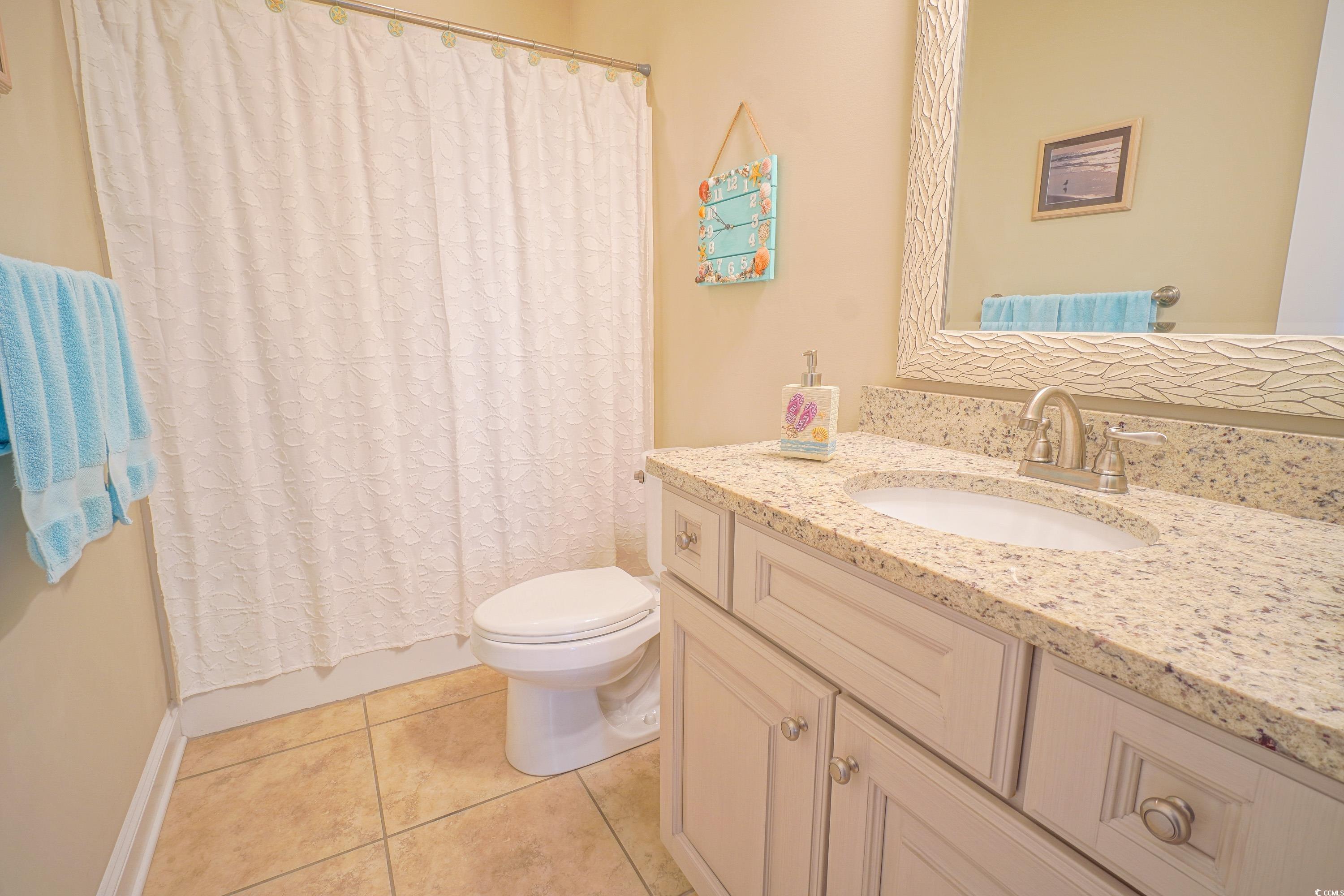 625 Whispering Pines Court Murrells Inlet, SC 29576 - Photo 24 of 36 Bathroom with toilet, shower / tub combo, tile patterned flooring, and vanity