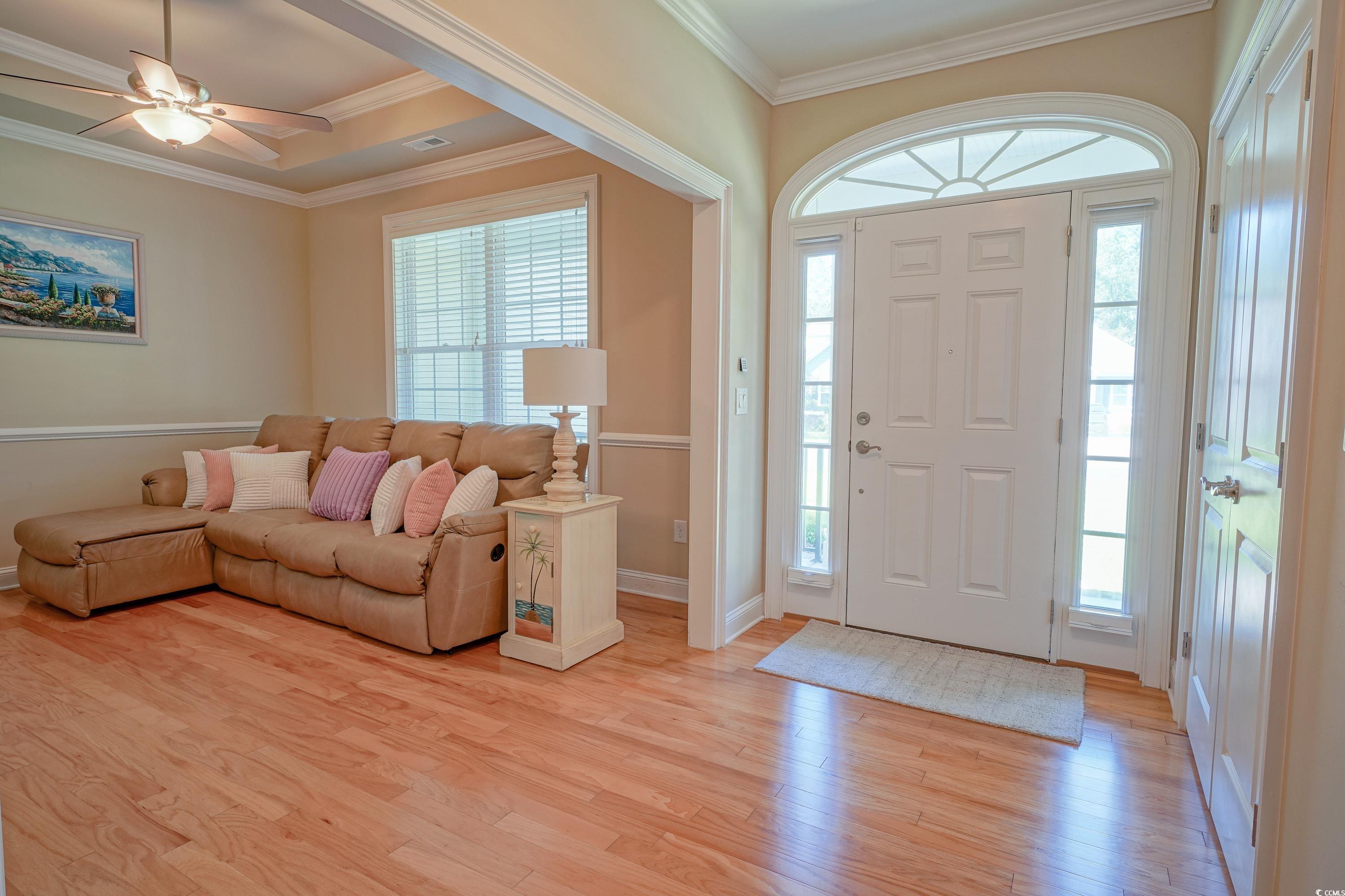 625 Whispering Pines Court Murrells Inlet, SC 29576 - Photo 4 of 36 Entryway with baseboards, plenty of natural light, ornamental molding, and light wood-style floors