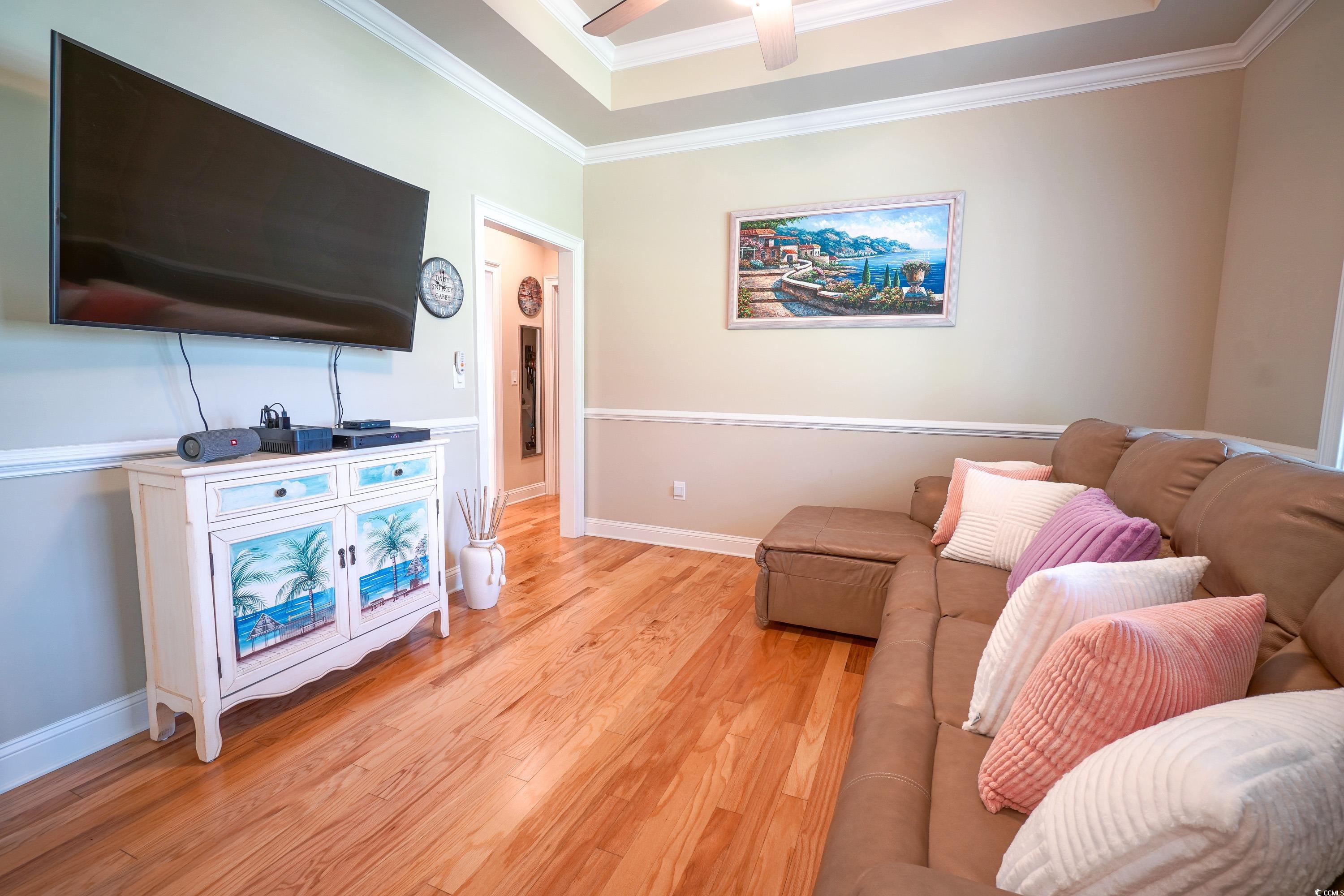 625 Whispering Pines Court Murrells Inlet, SC 29576 - Photo 5 of 36 Den/Dining Room featuring crown molding, a ceiling fan, light wood-style flooring, and a raised ceiling