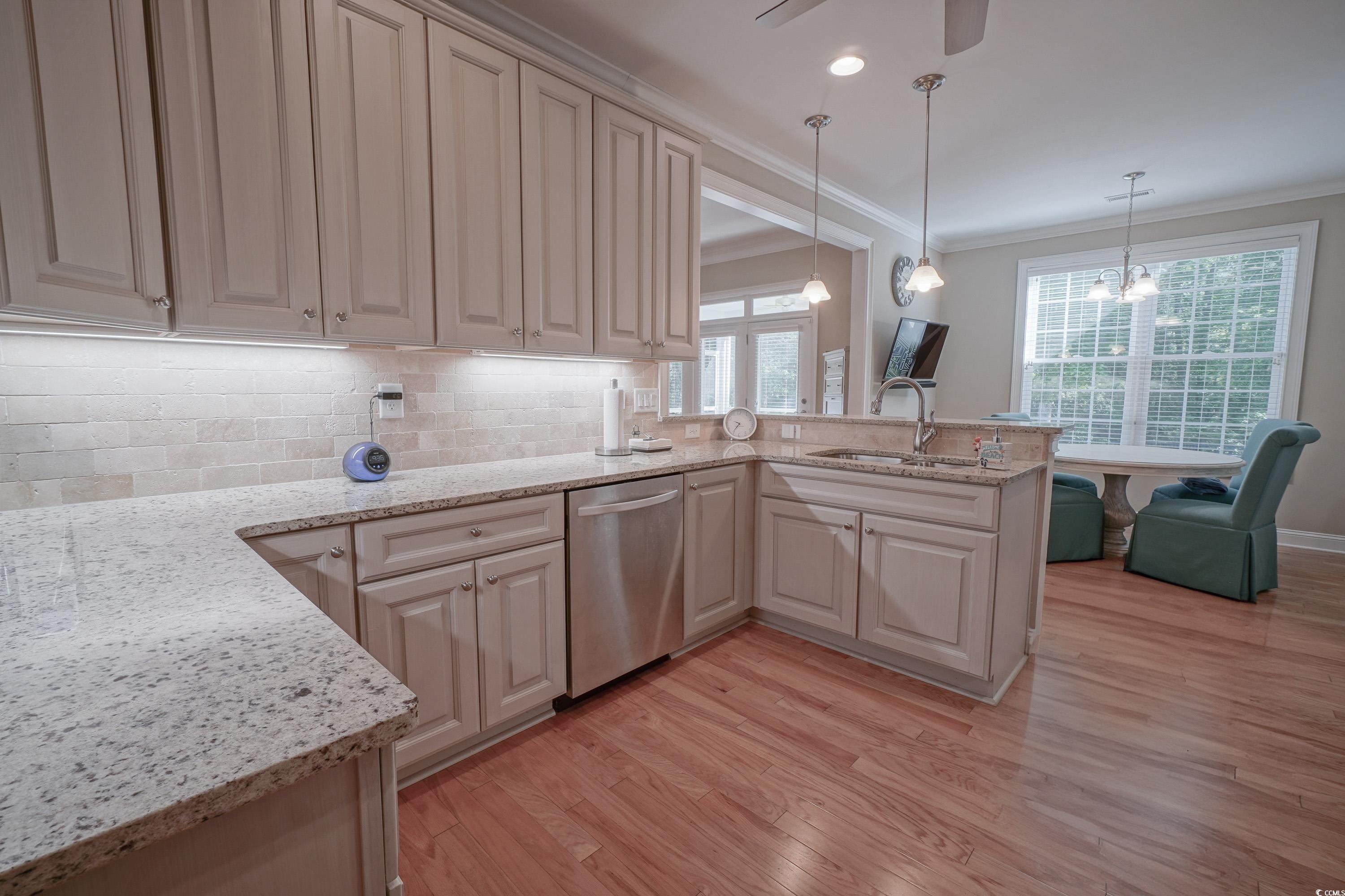 625 Whispering Pines Court Murrells Inlet, SC 29576 - Photo 9 of 36 Kitchen featuring crown molding, a peninsula, light wood-style floors, and dishwasher