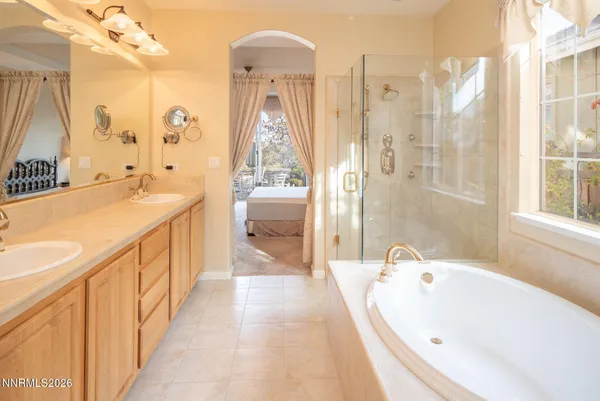 a spacious bathroom with a tub sink and shower