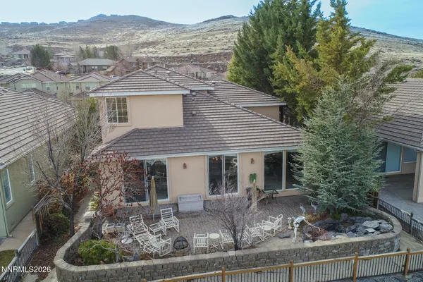 a front view of a house with a yard and mountain view