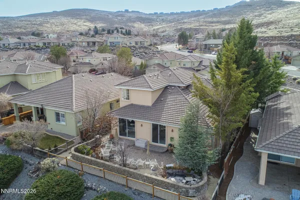 an aerial view of a house with a yard