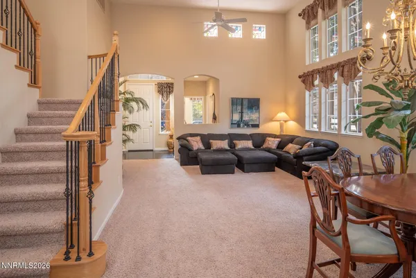 a living room with furniture and a chandelier