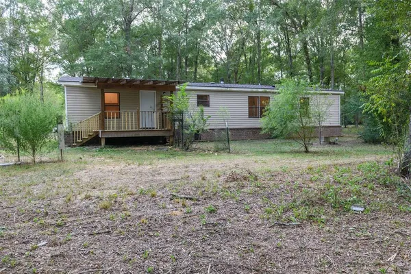 a view of house with backyard space and garden