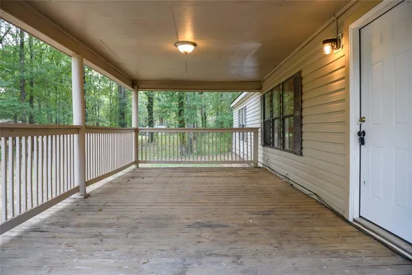 a view of a porch with wooden floor and outdoor space