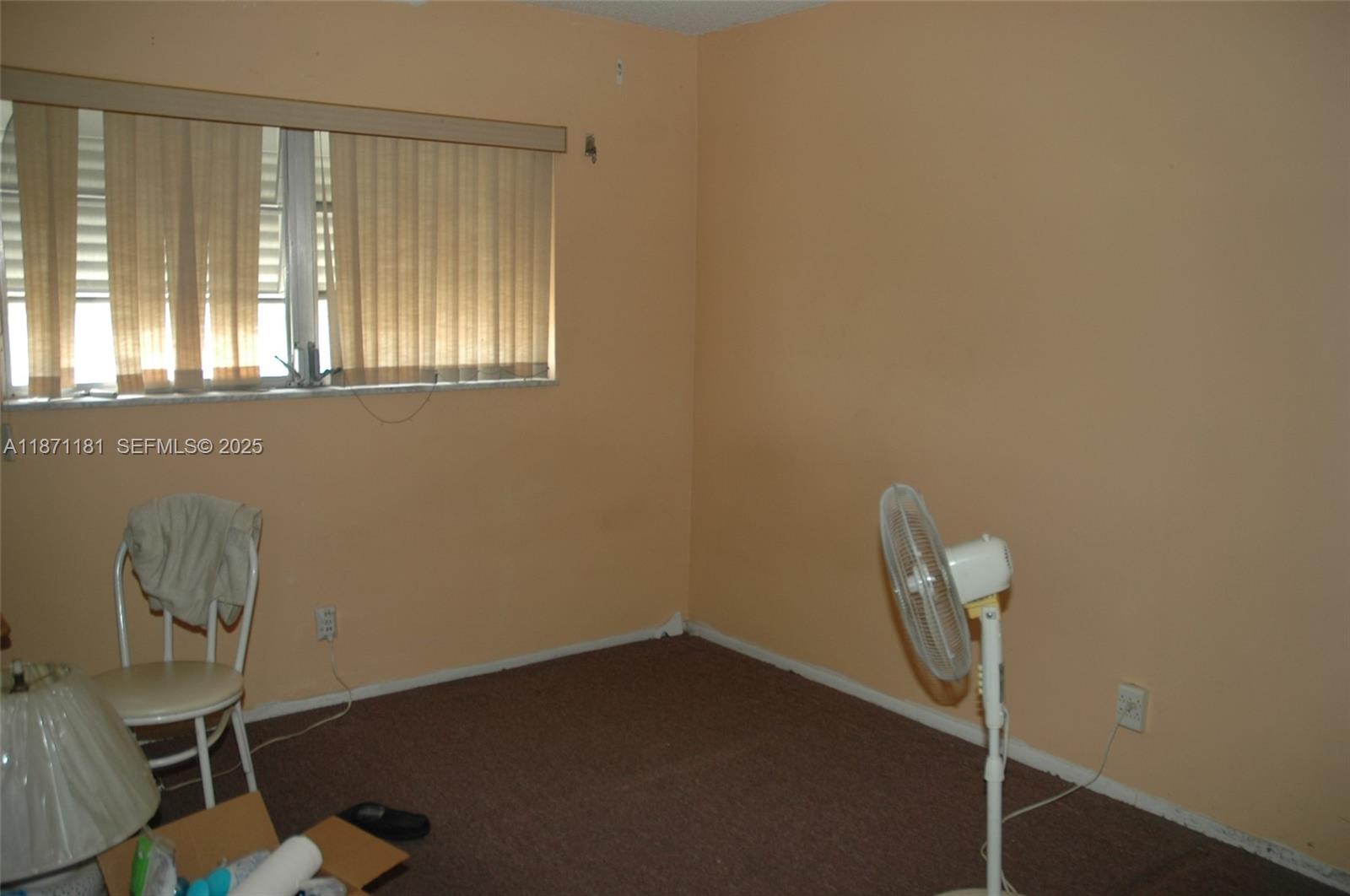 5300 Washington Street, Unit Q307 Hollywood, FL 33021 - Photo 16 of 21 a room with a chair and a window