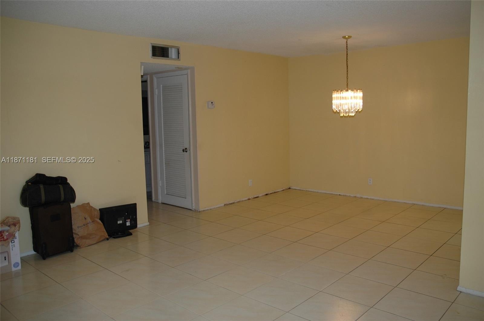 5300 Washington Street, Unit Q307 Hollywood, FL 33021 - Photo 10 of 21 a view of a livingroom with a table and chandelier