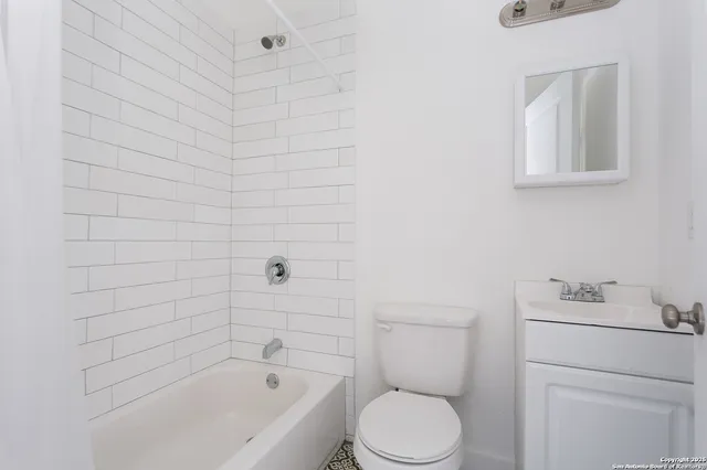 a bathroom with a toilet and bathtub