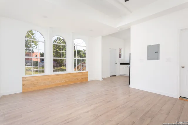 wooden floor in an empty room with a window