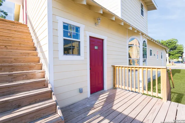 a view of a house with wooden deck