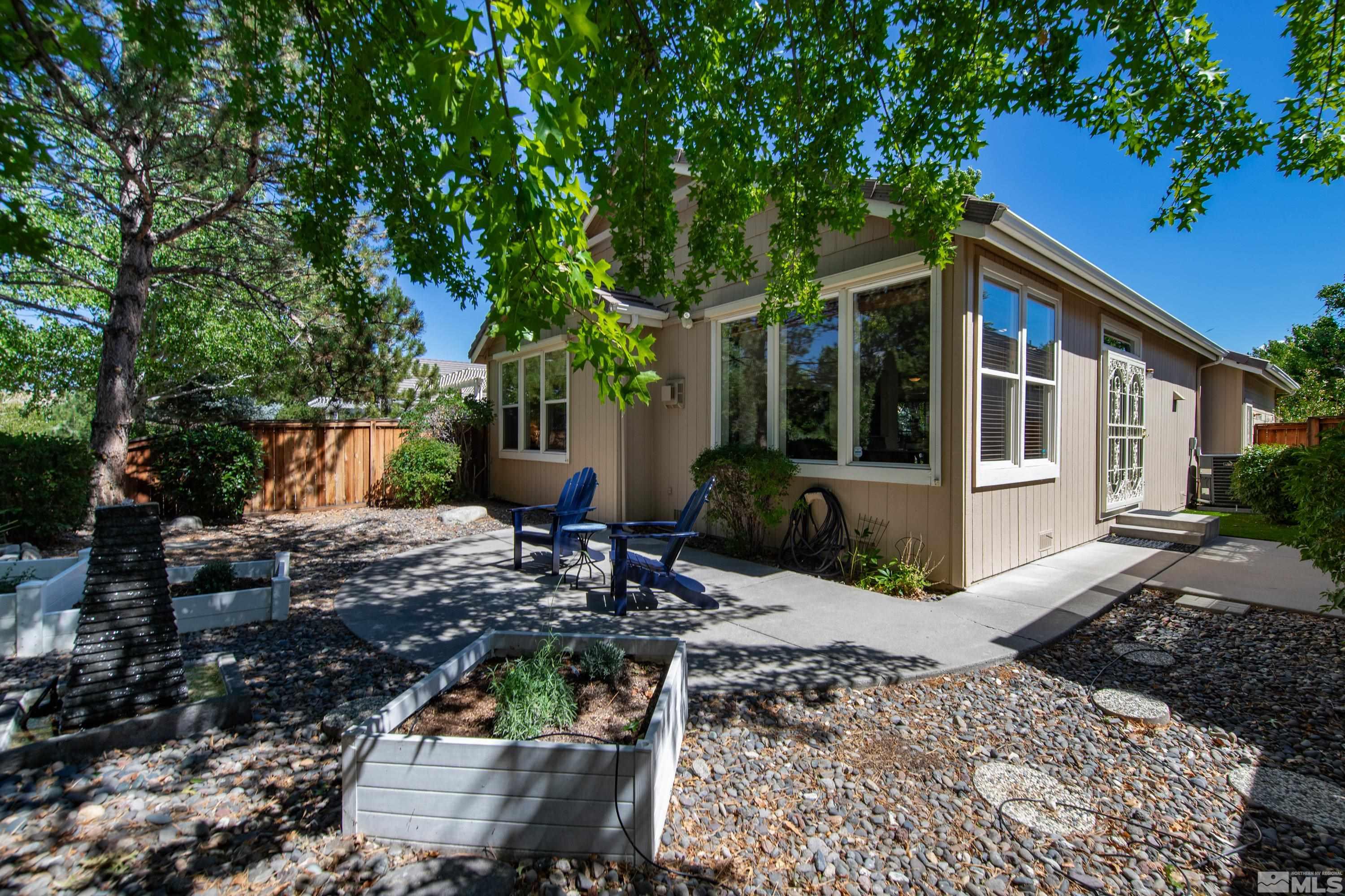 809 Caughlin Glen Reno, NV 89519 - Photo 18 of 23 a view of house with patio outdoor seating and covered with trees