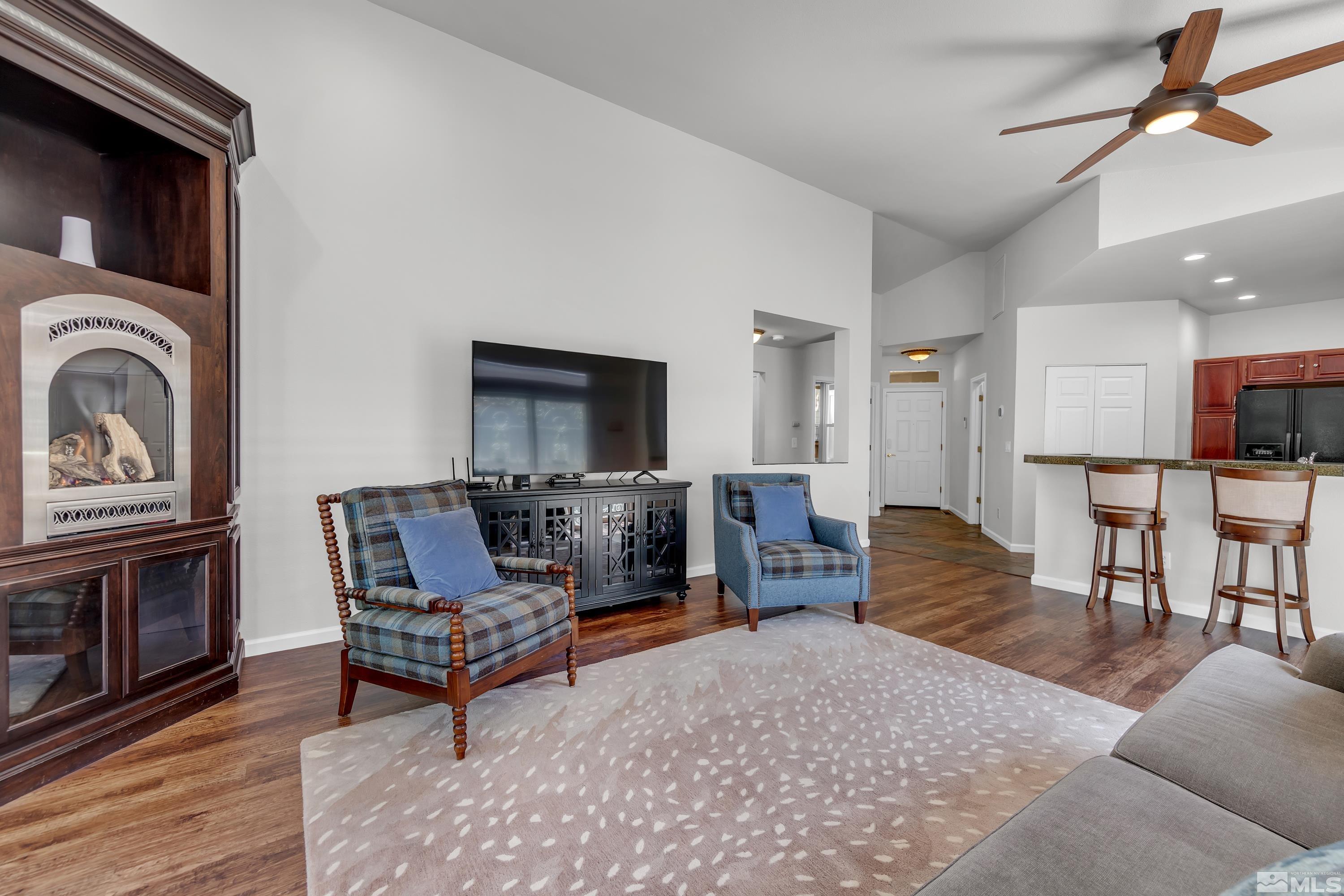 809 Caughlin Glen Reno, NV 89519 - Photo 8 of 23 a living room with furniture a flat screen tv and kitchen view
