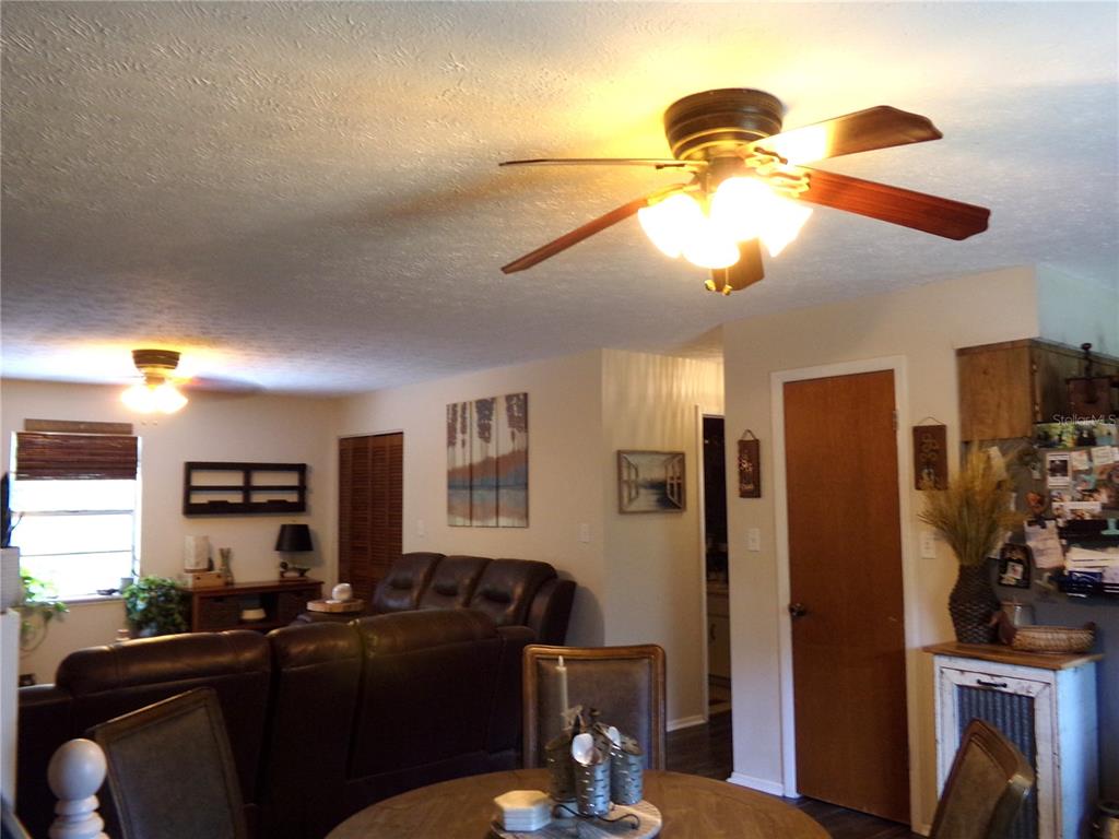 33068 Round Table Road Dade City, FL 33523 - Photo 51 of 82 a living room with furniture windows and a chandelier