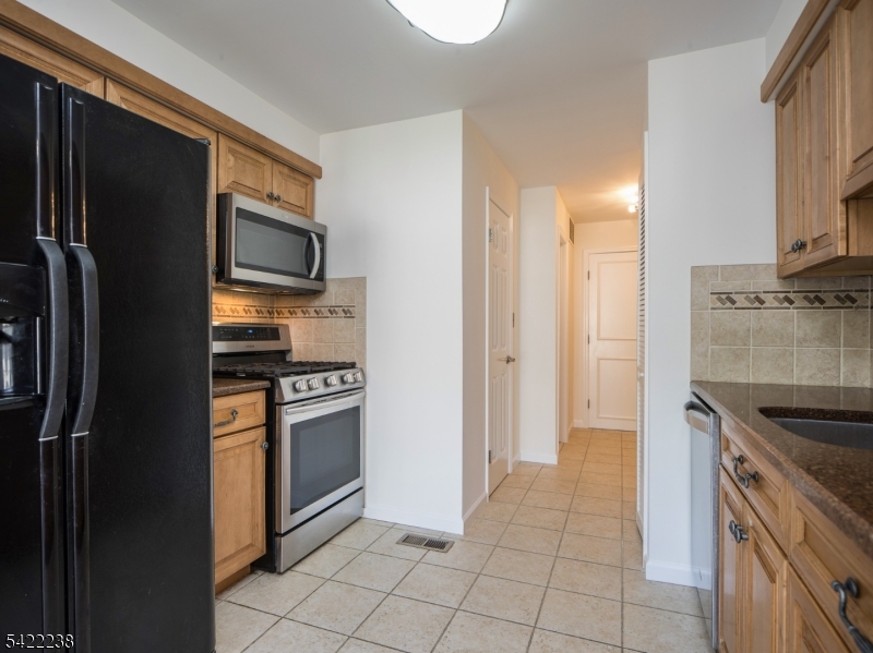 2301 Privet Way Bernards, NJ 07920 - Photo 9 of 30 a kitchen with stainless steel appliances granite countertop a refrigerator a stove and a sink