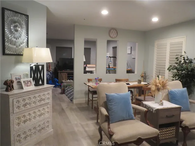 a living room with furniture a lamp and a table