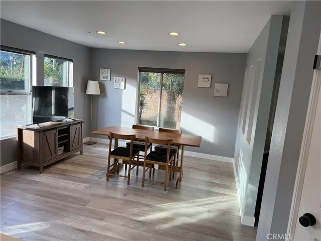 a view of a dining room with furniture and a window
