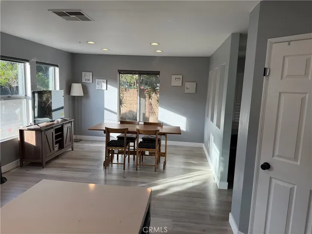 a view of a dining room with furniture window and wooden floor
