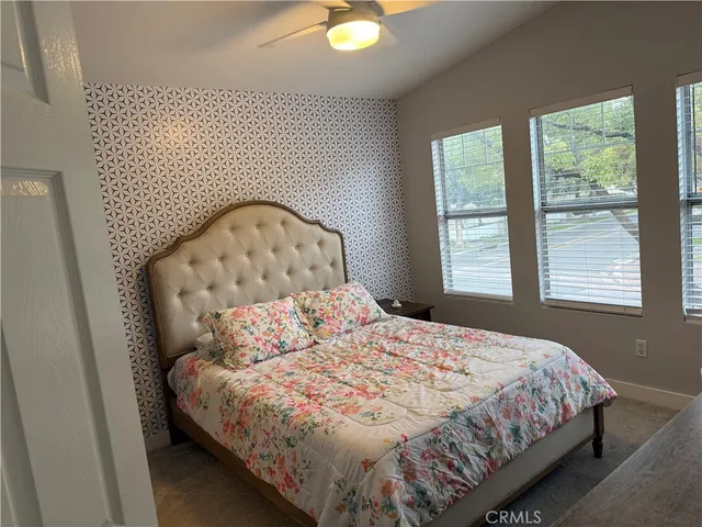 a bedroom with a bed and window