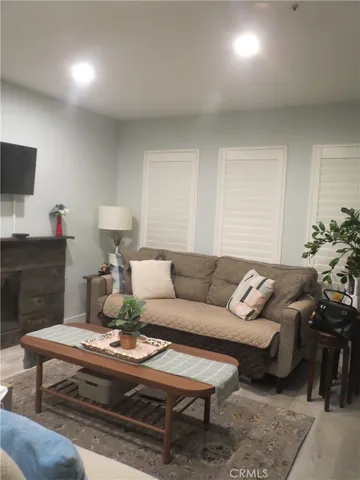 a living room with furniture a rug and a lamp