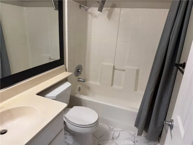 a bathroom with a sink a toilet a bathtub and shower