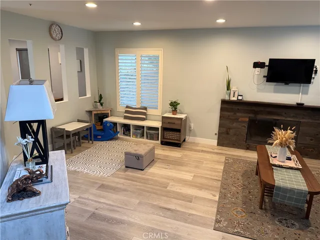 a living room with furniture a piano and a flat screen tv