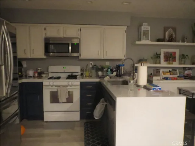 a kitchen with a sink a stove and cabinets