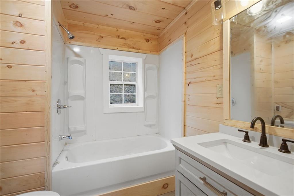 1780 Conasauga Road Ellijay, GA 30540 - Photo 12 of 43 a bathroom with a sink and a bathtub