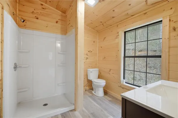 a bathroom with a toilet and a shower