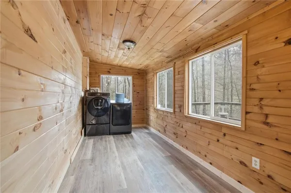 a big room with wooden floor and windows