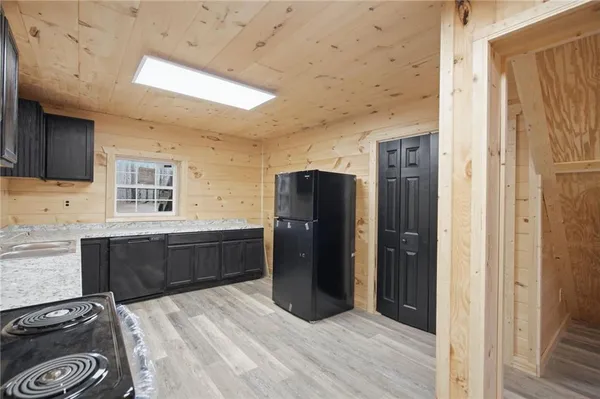 a kitchen with stainless steel appliances granite countertop a refrigerator and a stove top oven
