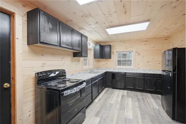 a kitchen with granite countertop stainless steel appliances and wooden cabinets