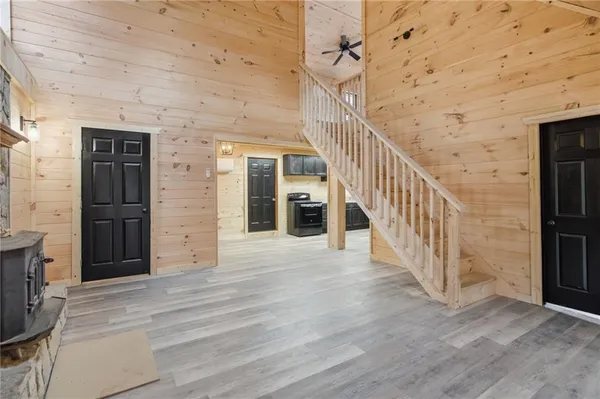 a view of a hallway with wooden floor and staircase