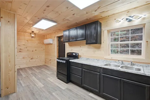 a kitchen with stainless steel appliances granite countertop a sink stove and cabinets